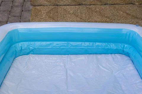 Close up view of inflatable children's pool in courtyard of house. Stock Photos