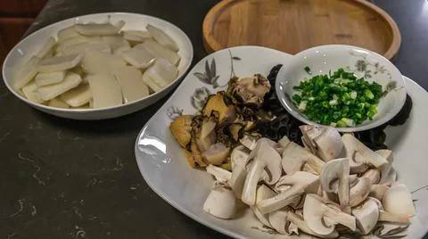 Close-up View Of Ingredients While Preparing Chinese Traditional Rice Cake Soup Stock Photos