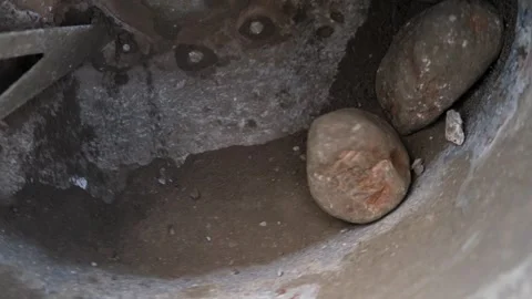 Close view inside corroded drain cavity with wet rock debris, rough metal brace Video stock 344879075