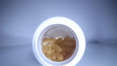 Close-up view inside jar of omega 3 Stock Footage 156757084