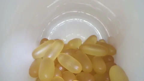 Close-up view inside jar of omega 3 Stock Footage 157083099