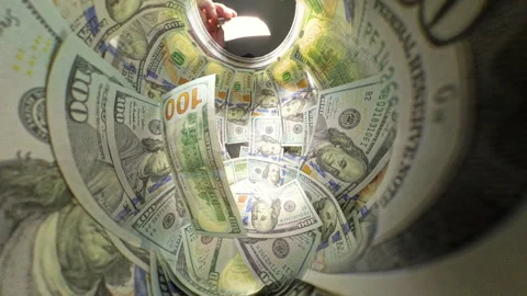 Close-Up View From Inside a Jar as a Stack of Hundred-Dollar Bills is Thrown Stock Footage 297190087