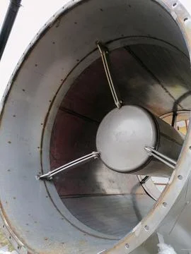 Close up view inside a large industrial metal pipe or ventilation duct Stock Photos