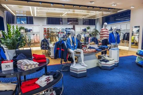 Close-up view inside Macy's with the Tommy Hilfiger men's clothing section. Stock Photos