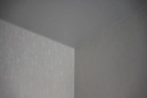 Close-up view of interior corner junction showing textured drywall walls meet Stock-Fotos