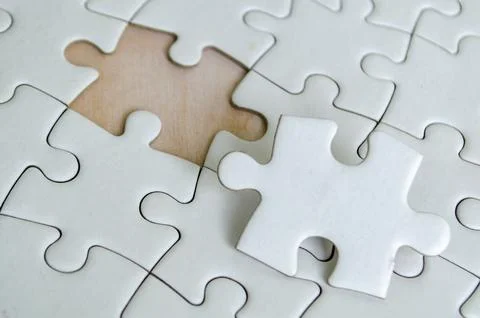 Close up view of interlocking jigsaw puzzle pieces symbolizing problem solv.. 스톡 사진