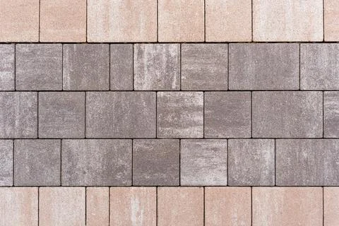 Close-up view of interlocking pavement blocks in various shades of gray and Stock Photos