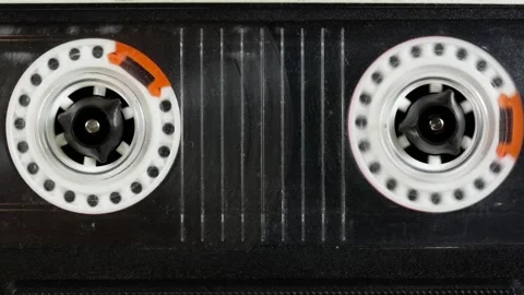 Close-up view of the internal reels of a compact cassette tape. Stock Footage 296107978