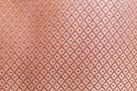 Close-up view of an intricate, embossed surface pattern with a stylized flo.. Fotos de archivo