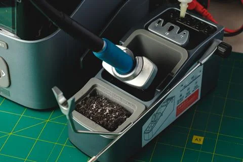 A close-up view of intricate soldering tools and components in action Stock Photos