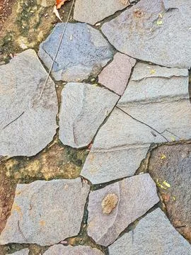 Close-up view of an irregular stone pavement with various shades and sizes of Stock Photos
