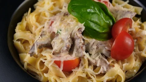 Close-up view of Italian pasta with meat, served with parmesan cheese Stock Footage 80708937