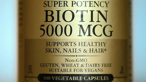 Close view of a jar with Biotin 5000 MCG pills, B7 vitamins. Slow motion Stock Footage 237713063