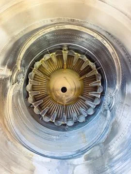 A close-up view of a jet engine reveals the intricate design of turbine blade Stock Photos