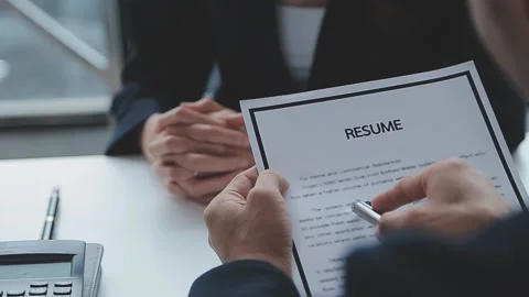 Close up view of job interview in office, focus on resume writing tips, emp.. Stock Footage 237776450