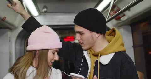 Close up view of joyful young couple looking at each other and singing while Stock Footage 136487115