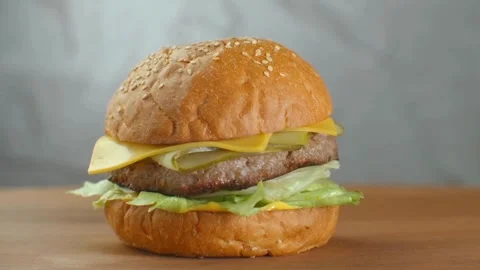 Close-up view. Juicy beef burger with cutlet, lettuce and sauce. vegetables, Big Stock Footage 336579384