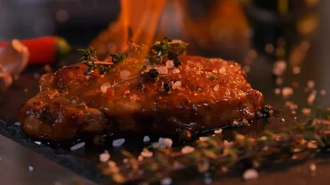 Close-up view of juicy cooked slice of meat and fresh vegetables with flames Video stock 107379729