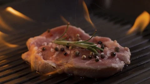 Close-up view of juicy cooked slice of meat with flames. bbq burn original Stock Footage 116591006