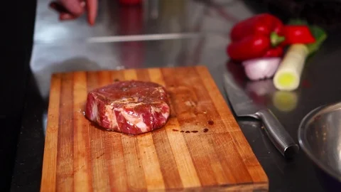 Close up view on juicy red thick slice of raw beef steak meet in spicy marinade Stock Footage 105456738