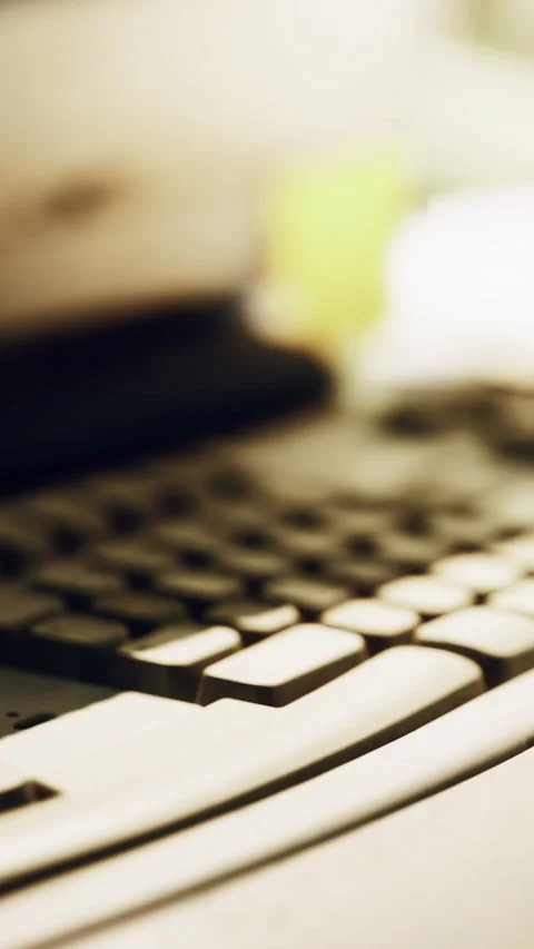 Close up view of keyboard and workspace with blurred background elements Stock Footage 341042416