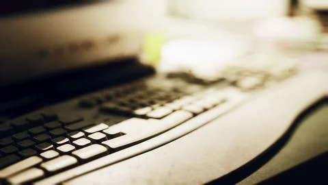 A close up view of a keyboard on a desk with soft ambient lighting Stock Illustration
