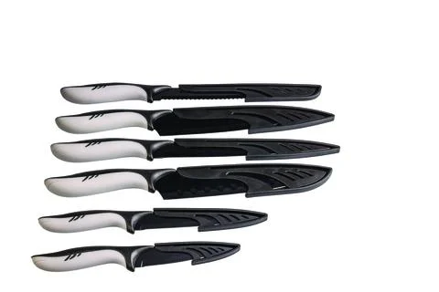 Close-up view of kitchen knives with protective covers isolated Fotos de archivo