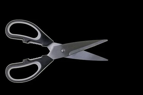 Close up view of kitchen scissors isolated on black background. Stock Photos