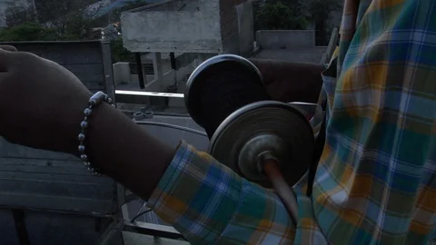 Close Up View Of Kite Spindle Being Spun Out Whilst Being Held In Arms, Stock Footage 117055838
