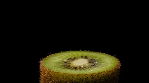 Close-up view of a kiwifruit on the rotating surface. Juicy green kiwifruit Stock Footage 105796429