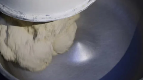 Close view of kneading the dough with an automated mixer on bakery factory Stock-Footage 146227356