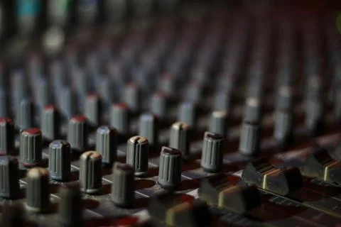Close up view of knobs and sliders of light and sound board console at a conc Stock Photos