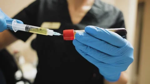 Close up view of Lab Worker hands Extracts blood Plasma Serum Layer to syringe Stock Footage 220505758