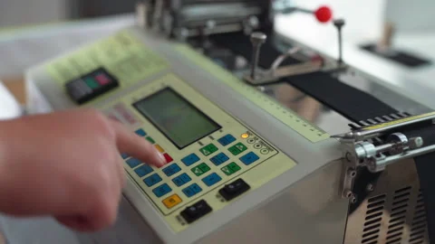 Close view of label printer controls with operator calibrating settings Stock Footage 321888882
