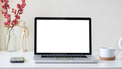 Close up view of laptop computer with blank screen, smartphone and coffee c.. Stock-Fotos