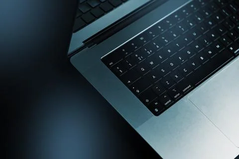 Close-up view of a laptop on a dark surface during a late evening setup for 写真素材