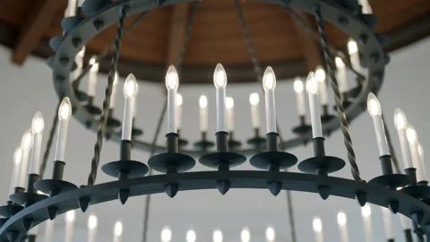 Close up view of large circular chandelier with multiple lit candle-shaped light Stock Footage 293850787
