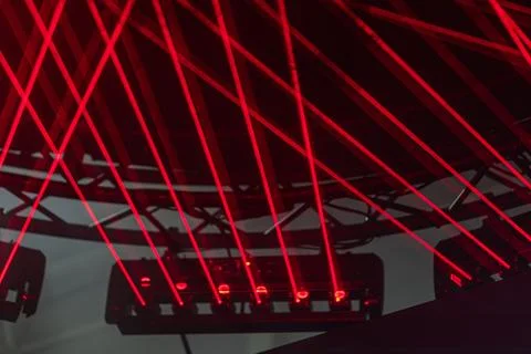 Close-up view of a large, circular LED light structure bathed in red light, s Stock Photos