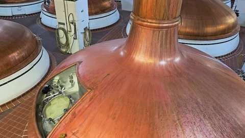 Close view of large copper beer vats in a brewery, showing fermentation Stock Footage 342663838