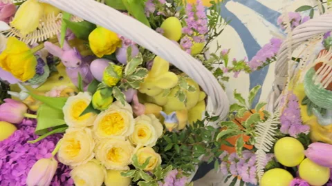 A close-up view of the large Easter baskets with lilac and yellow flowers and bu Video stock 306973901