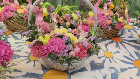 A close-up view of the large Easter baskets with lilac and yellow flowers and bu Stock Footage 306974041