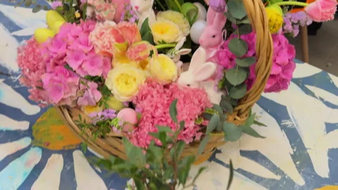 A close-up view of the large Easter baskets with pink flowers and bunnies on the Stock Footage 306974719