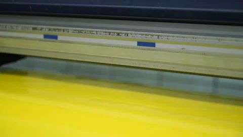 Close view large format plotter operates with yellow sheet Stockbeeldmateriaal 101287821