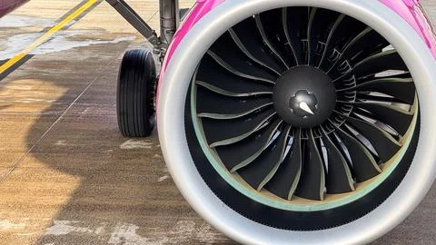 Close-up view of a large modern jet engine with distinctive pink and silver.. Stock Photos
