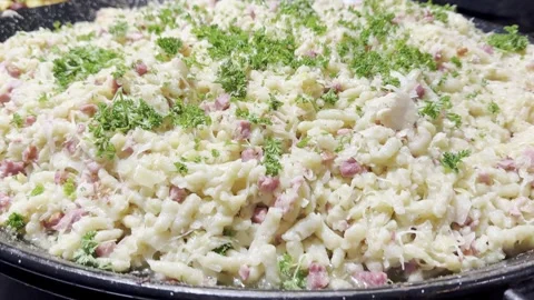 A close-up view of a large pot with a dish of cabbage and pasta gnocchi Stock Footage 291518506