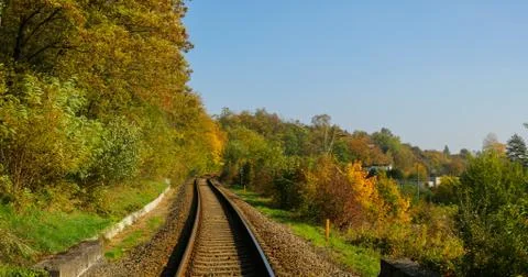 A close-up view of the large screws securing the train tracks during a sunny  스톡 사진