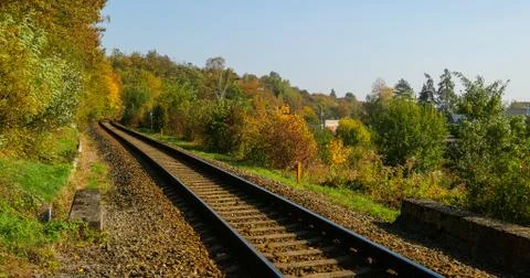 A close-up view of the large screws securing the train tracks during a sunny  Stock-Fotos