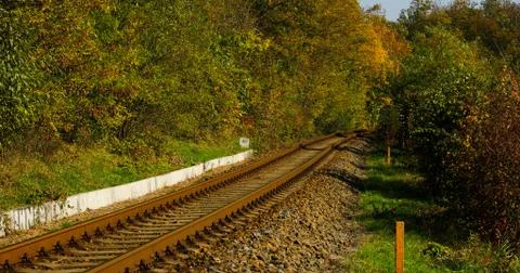 A close-up view of the large screws securing the train tracks during a sunny  Stock-Fotos