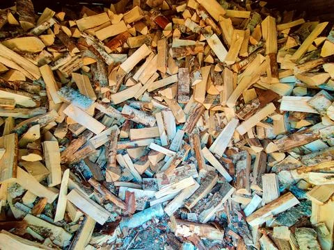 A close-up view of a large stack of split firewood pieces neatly arranged in  Stock Photos