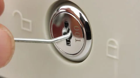 Close-up view on larva lock safe or cash drawer, try to open with piece of wire Stock-Footage 145535943